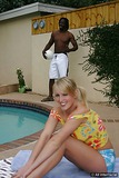 Sexy blonde strokes a fat black dick by pool