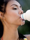 Insidious Asian Asia spreading milk on her big breasts outdoors