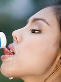 Insidious Asian Asia spreading milk on her big breasts outdoors