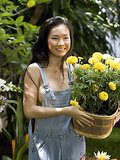Tempting Asian cutie Chau showing her round breasts in the garden