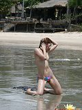 Erotic Asian Nari stripping lascivious her swimsuit on the beach